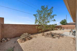 Fenced backyard with a patio