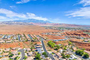 Aerial view of property's location with a mountainous background and nearby suburban area