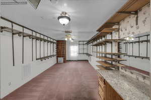 Interior space with dark carpet and a textured ceiling