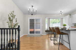 Dining room with a chandelier and light wood-type flooring