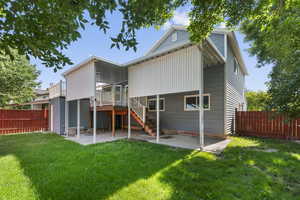 Back of house with a patio area, stairs, and a wooden deck