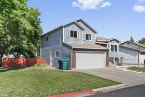 View of front of home with an attached garage, driveway, brick siding, and roof with shingles
