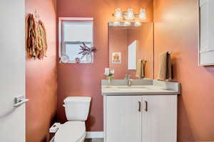 Half bathroom featuring toilet and vanity