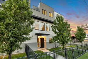 Contemporary house featuring a fenced front yard and stucco siding