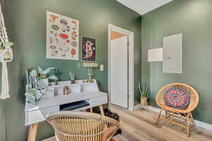 Office area featuring wood finished floors and electric panel