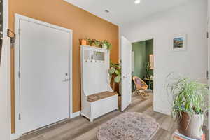 Mudroom with wood finished floors and recessed lighting