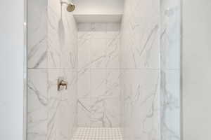 Full bathroom featuring a marble finish shower
