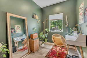Sitting room with wood finished floors and baseboards
