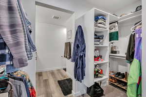 Spacious closet featuring wood finished floors