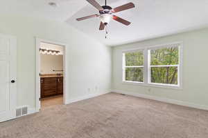 Primary Bedroom With Vaulted Ceilings and Fan