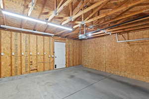 Well-lit Garage featuring a garage door opener