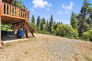 View of yard with stairway and a deck