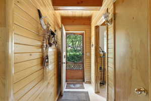 Entryway featuring wooden walls