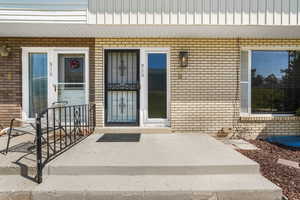 Doorway to property with brick siding