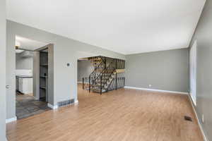 Empty room featuring wood finished floors and stairs