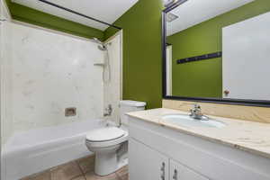 Full bathroom featuring vanity, shower / bathtub combination, and tile patterned floors