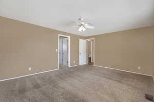 Empty room with carpet and ceiling fan