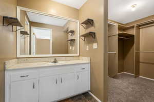 Bathroom featuring vanity and baseboards
