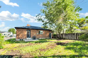 Rear view of property with a patio area and a chimney