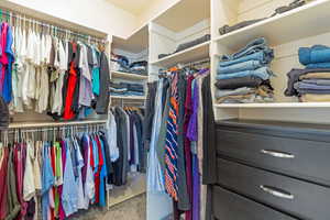 Spacious closet featuring carpet flooring