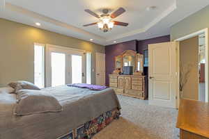 Bedroom featuring a tray ceiling, carpet flooring, recessed lighting, and ceiling fan
