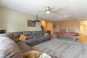 Carpeted family room / theater with projector and surround sound.