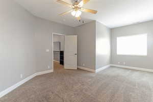 Unfurnished bedroom featuring carpet flooring and ceiling fan