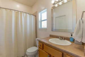 Full bathroom with vanity and curtained shower