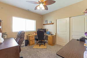 Bedroom area with light colored carpet and ceiling fan