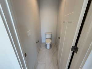 Bathroom with baseboards and toilet