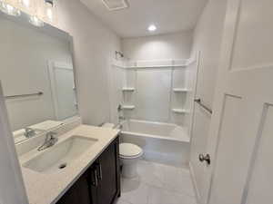 Full bath with vanity, washtub / shower combination, and marble finish flooring