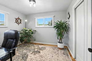 Home office with wood finished floors and baseboards