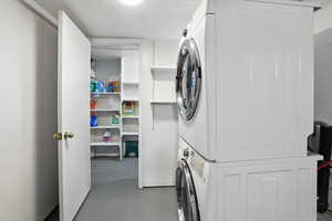 Laundry room featuring stacked washer and clothes dryer