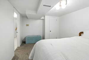 Carpeted bedroom with a textured ceiling