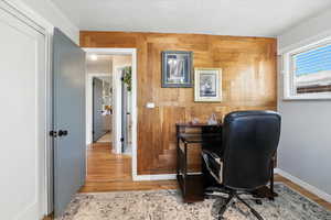 Office space featuring wood walls and wood finished floors