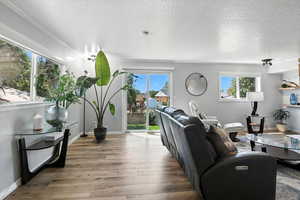 Living area featuring a textured ceiling and wood finished floors
