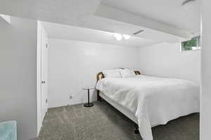 Bedroom featuring a textured ceiling and carpet flooring