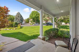 Covered porch with a lawn
