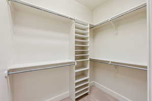 Walk in closet with carpet floors