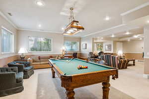 Recreation room featuring a wainscoted wall, carpet flooring, pool table, crown molding, and recessed lighting