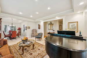 Welcome area with ornamental molding, recessed lighting, and a chandelier