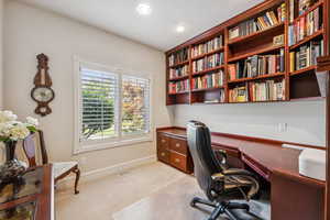 Office space featuring light carpet and baseboards