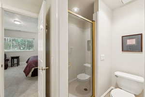Full bathroom featuring a shower stall and connected bathroom