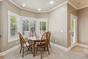 Dining area featuring crown molding, carpet floors, and recessed lighting