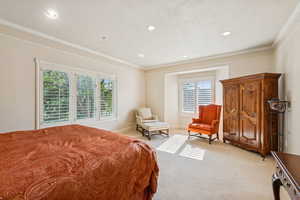 Bedroom featuring ornamental molding, light carpet, and recessed lighting