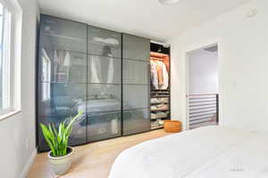 Bedroom featuring wood finished floors and baseboards