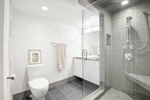 Bathroom with a stall shower, tile patterned flooring, vanity, and recessed lighting
