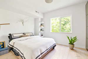 Bedroom featuring light wood-style flooring and baseboards