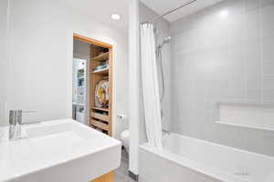 Bathroom featuring tiled shower / bath combo, tile patterned floors, and recessed lighting