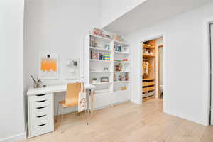 Office area with light wood-type flooring and baseboards